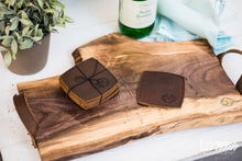 Wood charcuterie board with leather coasters.