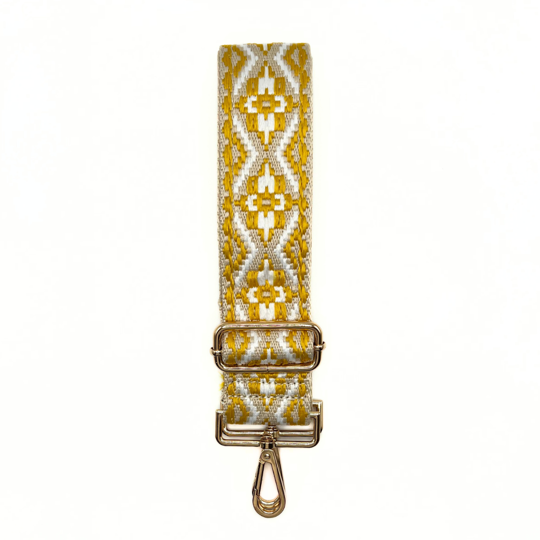 Yellow and white adjustable crossbody strap with a geometric pattern and metal hardware, displayed on a white background