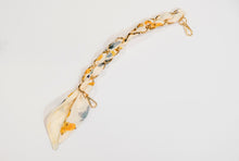 Gold scarf chain with with yellow and blue flowers for purse.