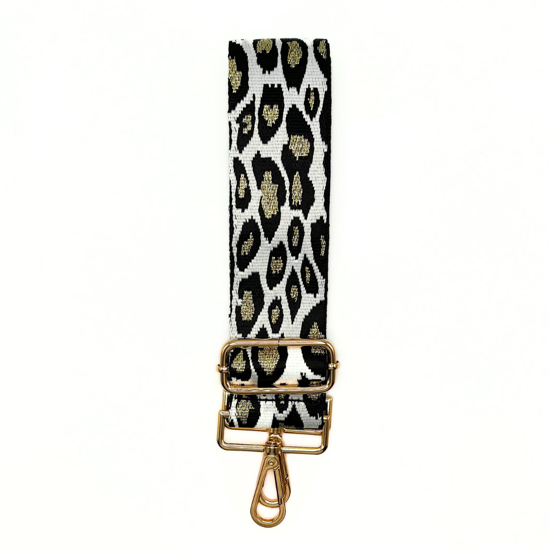 Gold and black adjustable crossbody strap with a cheetah pattern and metal hardware, displayed on a white background