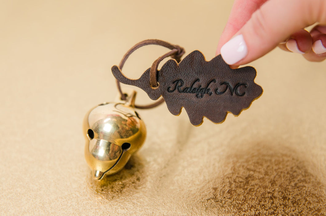 Acorn ornament with leather leaf engraved with Raleigh, NC.