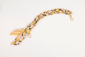 Gold scarf chain with pink and yellow flowers for purse.